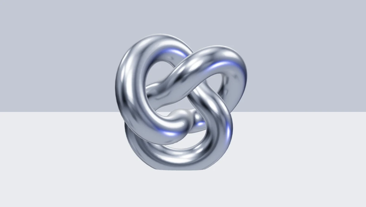 A reflective silver knot in a pale studio.